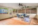 Inviting screened-in porch with terracotta floors, ceiling fan, and ample natural light at 2360 Elon Way, Decatur, GA 30033