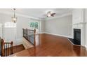 Spacious living room with a fireplace, hardwood floors, and a front door at 2313 Millhaven St, Smyrna, GA 30080
