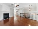 Open living area with hardwood floors, fireplace, and staircase to the upper level at 2313 Millhaven St, Smyrna, GA 30080