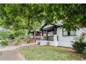 Street view of craftsman bungalow home with brick foundation, covered porch and manicured lawn at 554 Lawton Sw St, Atlanta, GA 30310