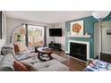 Inviting living room with a fireplace, window seat, and stylish decor at 133 Maison Nw Pl, Atlanta, GA 30327