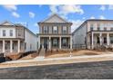 Beautiful two-story brick home with a covered front porch and professional landscaping at 173 Basil St, Cumming, GA 30040