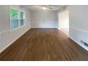Bright living room with hardwood floors, and a large window with lots of natural light at 2067 Wellborn Close, Lithonia, GA 30058