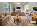 Bright living room with hardwood floors, neutral furniture, and a large window with lots of natural light at 2067 Wellborn Close, Lithonia, GA 30058
