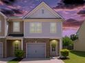 Inviting two-story townhome with warm lighting, brick details, and a cozy, welcoming entrance at 4925 Longview Walk, Decatur, GA 30035