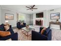 Cozy living room features a fireplace, stylish furniture, and a ceiling fan at 2930 Parc Lorraine, Lithonia, GA 30038