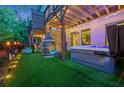 Relaxing backyard space with hot tub, hanging chair, and privacy fence at 3028 Pruitt Ln, Smyrna, GA 30080