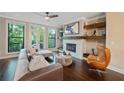 Cozy living room with fireplace, large windows, balcony access, and hardwood floors at 3028 Pruitt Ln, Smyrna, GA 30080