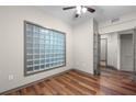 Bright bedroom boasts stylish wood floors, natural light from unique glass block window, and french doors to another room at 390 17Th Nw St # 5008, Atlanta, GA 30363