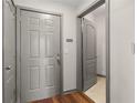 Cozy entryway featuring a wooden floor, a gray front door, and an adjacent closet at 390 17Th Nw St # 5008, Atlanta, GA 30363
