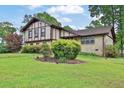 Lovely home with lush green lawn and mature trees creating a serene setting at 2272 Plantation Ct, Lawrenceville, GA 30044