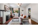 Bright living room featuring a decorative fireplace, hardwood floors, and comfortable seating arrangement at 509 Rankin Ne St, Atlanta, GA 30308