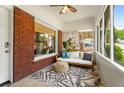 Inviting screened porch with brick accents, comfortable seating, stylish rug, and ample natural light at 509 Rankin Ne St, Atlanta, GA 30308
