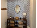 Stylish entryway featuring patterned wallpaper, console table, and decorative accents at 186 Sunshower Rdg, Canton, GA 30114