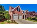 Beautiful brick home featuring a two-car garage and landscaped yard at 2119 Wrights Mill Ne Cir, Atlanta, GA 30324