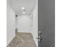 Hallway with white walls, concrete floor, and a door on the right at 346 Peters Sw St # 207, Atlanta, GA 30313