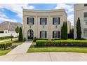 Stately two-story home with arched entryway, black shutters, manicured hedges, and lush green lawn at 316 S Esplanade, Alpharetta, GA 30009