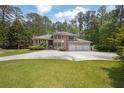 Spacious brick home with three-car garage on a large lot provides an inviting appeal at 5302 Greenway Dr, Villa Rica, GA 30180