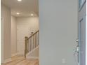 Bright foyer with hardwood floors and staircase leading to the upper level at 1976 Deco Dr, Kennesaw, GA 30144