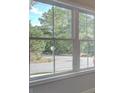 A view from the window of a quiet street and lush trees at 1976 Deco Dr, Kennesaw, GA 30144