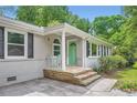 Cozy front porch with stone steps, columns and a light green door at 2205 Desmond Dr, Decatur, GA 30033