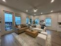 Spacious living area with light-filled windows, hardwood floors, and stylish neutral furnishings at 920 Hughley Circle # 74, Atlanta, GA 30316