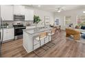 Open-concept kitchen featuring an island with granite countertops and stainless steel appliances at 9462 Pinecrest Path # 319, Jonesboro, GA 30238