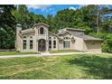 Charming exterior view of the home showcasing the well maintained front yard and unique architecture at 387 Nickajack Se Rd, Mableton, GA 30126