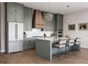 Modern kitchen featuring stainless steel appliances, pendant lighting, and a center island with seating at 4011 Chamblee Dunwoody Rd, Chamblee, GA 30341