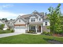 Beautiful two-story home with a well-kept lawn, a pergola, and a welcoming front porch in a suburban setting at 410 Crestbrook Ln, Dallas, GA 30157