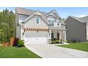 Attractive two-story home with a pergola over the garage and a manicured lawn, nestled in a suburban landscape at 410 Crestbrook Ln, Dallas, GA 30157