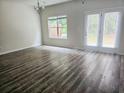 Bright living area with wood floors, large windows, and a door leading to the backyard at 1529 Iris Walk, Jonesboro, GA 30238