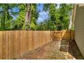 Newly installed wooden fence encloses the private backyard, providing security and privacy at 1660 Rose Garden Ln, Loganville, GA 30052