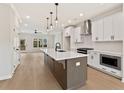 Modern kitchen boasts a large center island, stainless steel appliances, and sleek white cabinetry at 1995 Deco Dr, Kennesaw, GA 30144