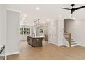 Open-concept living area combines the kitchen, dining, and living spaces, complete with hardwood floors at 1995 Deco Dr, Kennesaw, GA 30144