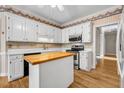 Bright kitchen with island, white cabinetry, and stainless steel appliances at 3171 Blairhill Ct, Atlanta, GA 30340
