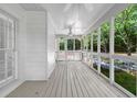 A screened porch with wood floors offers an airy space for enjoying the outdoors while being protected from insects at 3171 Blairhill Ct, Atlanta, GA 30340