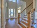 Bright foyer with hardwood floors and staircase, leading to the front door at 3745 Reserve Overlook (#30) Way, Cumming, GA 30041