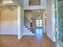 Bright foyer with hardwood floors, a staircase, and a view into other rooms at 3745 Reserve Overlook (#30) Way, Cumming, GA 30041