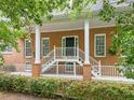 Stately brick home featuring a covered front porch with prominent white columns at 4515 N. Slope Cir, Marietta, GA 30066