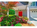 An eye-catching red door nestled within a welcoming carriage and beautiful landscaping at 5800 Villa Rica Hwy, Dallas, GA 30157