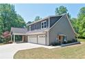Beautiful two-story home with three-car garage, carriage and gray siding at 5800 Villa Rica Hwy, Dallas, GA 30157