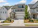 Attractive two-story home with a neutral color scheme, tidy landscaping, and a welcoming front porch in a suburban setting at 1225 Westshore Dr, Cumming, GA 30041