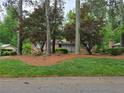 View of the home from the street showcasing mature landscaping at 1810 Trophy Dr, Marietta, GA 30062