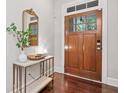 Warm entryway with a wood front door, elegant marble-top console table, and stylish decor at 2801 Avington Se Ln, Smyrna, GA 30080