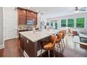 Open-concept kitchen boasts a large island with seating, granite countertops, and stainless steel appliances at 2801 Avington Se Ln, Smyrna, GA 30080