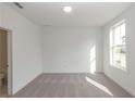 Bright bedroom with plush carpet and a large window fills the space with light at 4253 Millcroft Pl # 198, Buford, GA 30518