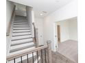 Bright staircase with wooden handrail and carpeted steps for a modern look at 4253 Millcroft Pl # 198, Buford, GA 30518