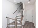 Staircase with wood and black iron railing adds a touch of modern elegance at 4253 Millcroft Pl # 198, Buford, GA 30518