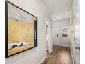 Beautiful hallway with wood-look floors, decorative painting, and doors leading to various rooms at 9454 Pinecrest Path # 315, Jonesboro, GA 30238